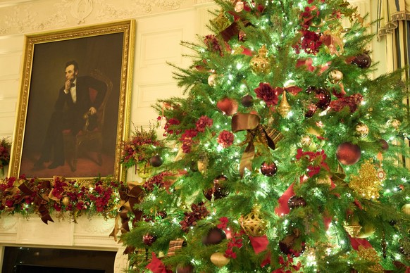 A Christmas tree decorates the State Dining Room of the White House during a press preview of the Christmas decorations &quot;Home is Where the Heart Is,&quot; Monday, Dec. 1, 2025, in Washington. (AP ...