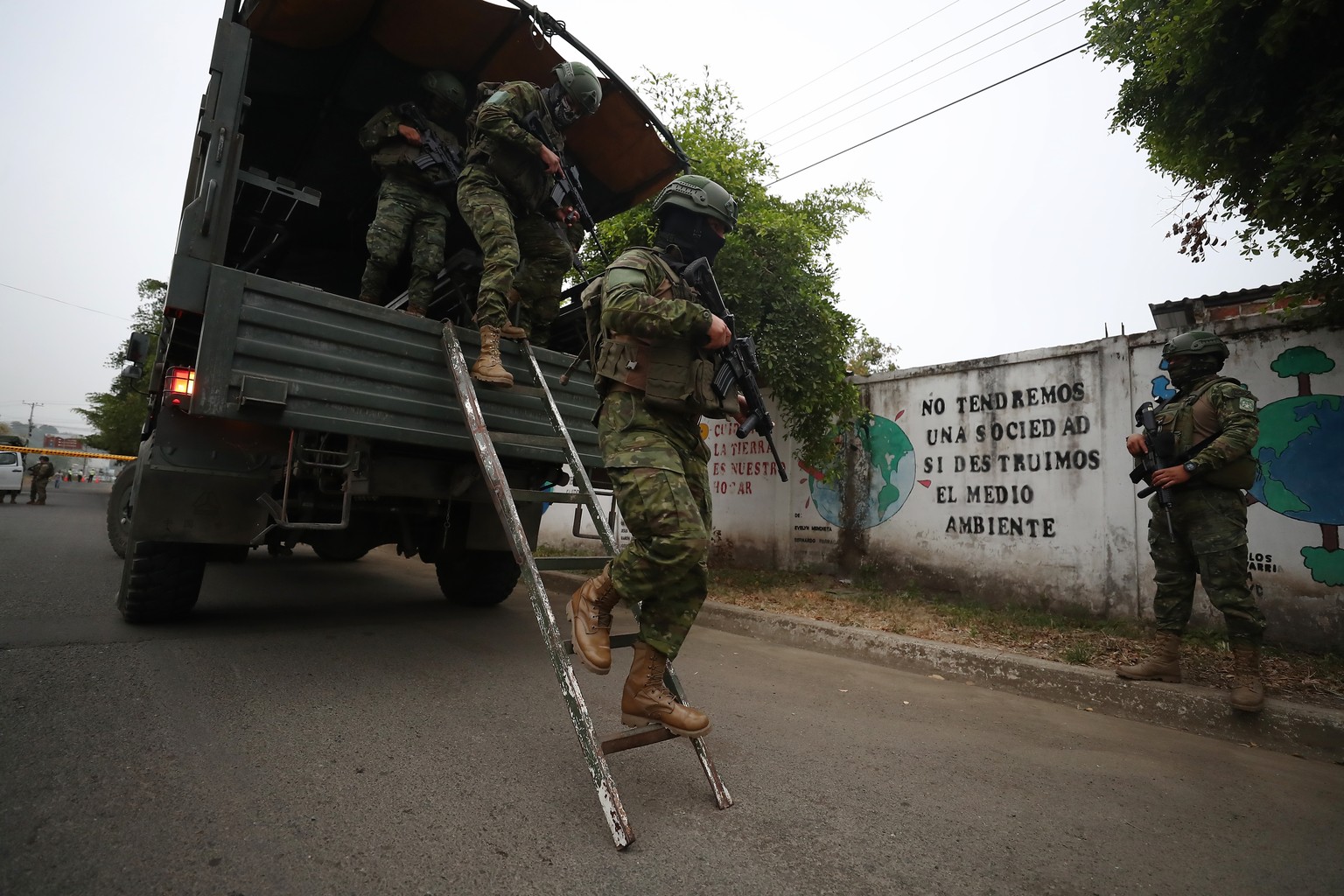 epa10920203 Soldiers are deployed to secure safety outside the polling station where candidate Luisa Gonzalez will cast her vote in Canuto, Manabi province, Ecuador, 15 October 2023. In the second rou ...