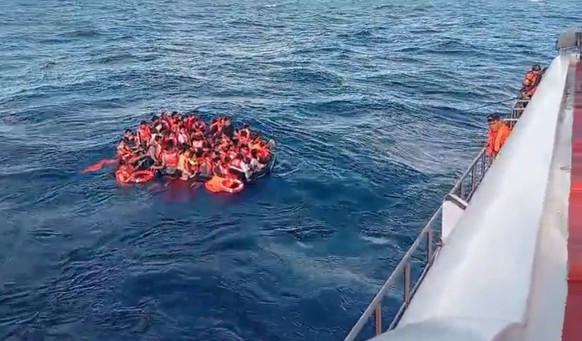 epa13162712 A handout photo made from video released by Indonesias Rescue Agency (Basarnas) shows survivors from a burning ferry floating on the water off Lombok Island, West Nusa Tenggara Province,  ...