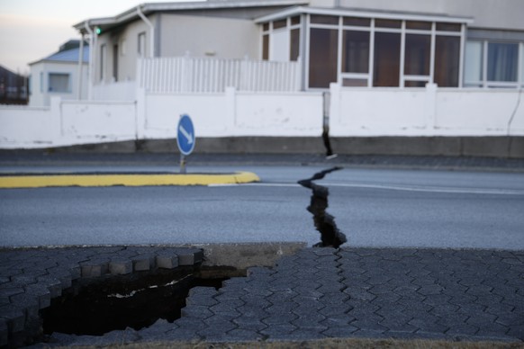 A fissure stretches across a road in the town of Grindavik, Iceland Monday Nov. 13, 2023 following seismic activity. Residents of Grindavik, a town in southwestern Iceland, have been briefly allowed t ...