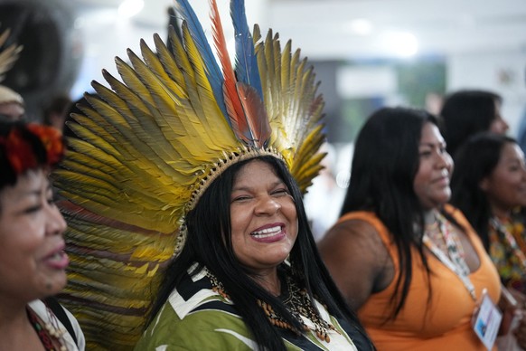 Brazilian Indigenous Peoples Minister Sonia Guajajara speaks to members of the media as she walks through the venue for the COP30 U.N. Climate Summit, Wednesday, Nov. 12, 2025, in Belem, Brazil. (AP P ...