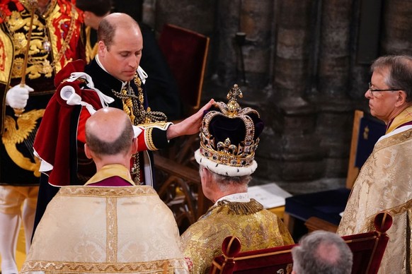 LONDON, ENGLAND - MAY 06: Prince William, Prince of Wales touches the St Edward's Crown his father's, King Charles III during the King's Coronation Ceremony inside Westminster Abbey on ...