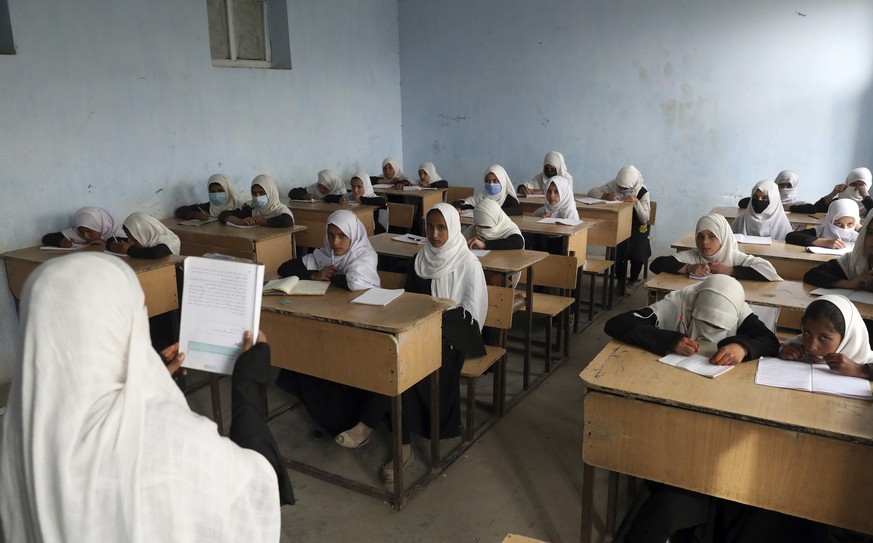FILE - Afghan girls students attend school classes in a primary school in Kabul, Afghanistan, Saturday, March 27, 2021. Schools for all students will open this week, Afghanistan&#039;s Taliban-run Edu ...