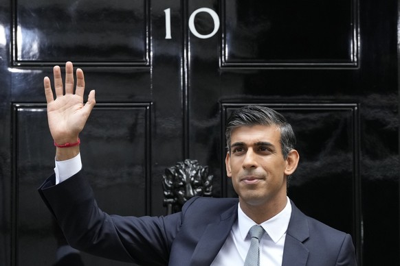 FILE - New British Prime Minister Rishi Sunak waves after arriving at Downing Street in London, Tuesday, Oct. 25, 2022, after returning from Buckingham Palace where he was formally appointed to the po ...