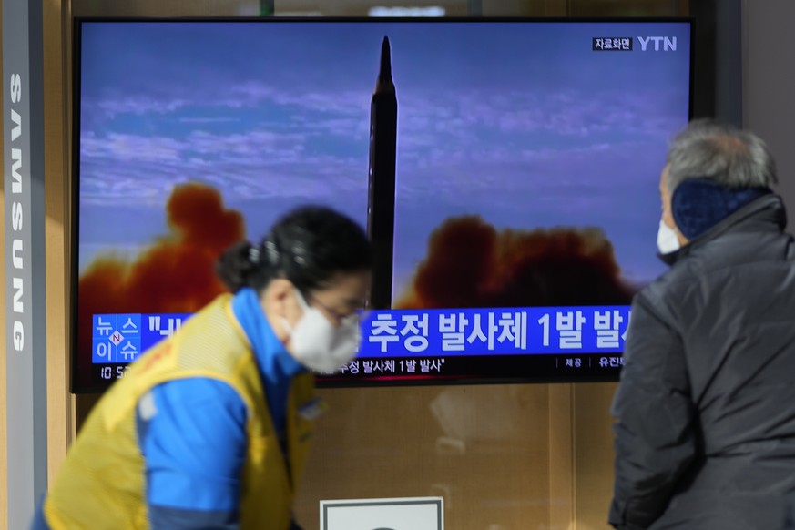 People stand near a TV screen showing a news program reporting about North Korea&#039;s missile with file footage at a train station in Seoul, South Korea, Wednesday, Jan. 5, 2022. North Korea fired a ...