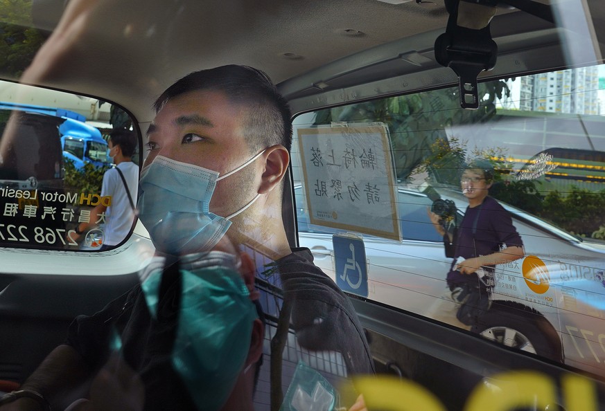 File- In this Monday, July 6, 2020, file photo, Tong Ying-kit, 23 years old, arrives at a court in a police van for the violation of the new security law after carrying a flag reading &quot;Liberate H ...