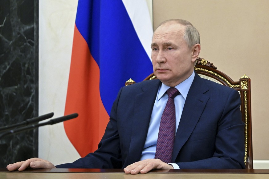 Russian President Vladimir Putin listens to Russian Russian Defense Minister Sergei Shoigu during their meeting in Moscow, Russia, Monday, Feb. 14, 2022. Moscow wants guarantees from the West that NAT ...