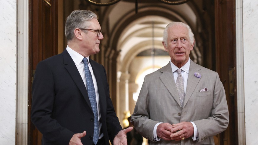 Britain&#039;s King Charles, right, walks with Britain&#039;s Prime Minister Keir Starmer during the European Political Community meeting, near Oxford, England, Thursday July 18, 2024. (Hollie Adams/P ...