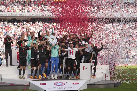 Bayern Munich players celebrate winning the German championship after the German Bundesliga soccer match between 1.FC Cologne and FC Bayern Munich in Cologne, Germany, Saturday, May 27, 2023. (AP Phot ...