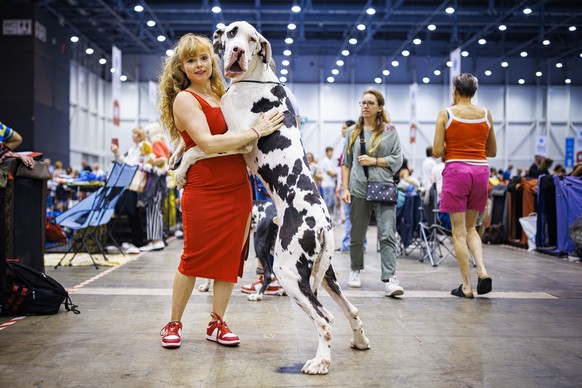 A woman poses with her dog during the "world dog show 2023" competiton in Geneva, Switzerland, Saturday, August 26, 2023. Participants from 80 countires are presenting over 21'500 dogs ...