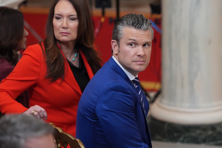 epa12865485 US Defense Secretary Pete Hegseth (R) and US Agriculture Secretary Brooke Rollins (L) arrive before President Donald Trump speaks about the Iran war from the Cross Hall of the White House  ...