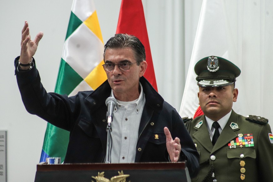 epa13024961 Bolivian President Rodrigo Paz (L) speaks at a press conference where he signed into law the State of Emergency Regulation Act to authorize the Armed Forces to intervene in controlling pro ...