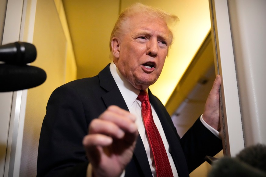 President Donald Trump speaks to reporters aboard Air Force One, Sunday, Oct. 19, 2025, en route to Joint Base Andrews, Md., as he returns from a trip to Florida. (AP Photo/Mark Schiefelbein)
Donald T ...
