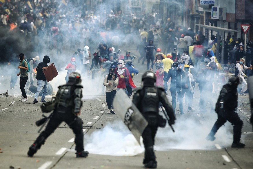 epa09355754 Demonstrators clash with members of the Mobile Anti-Riot Squad (ESMAD) of the Colombian Police at the Loma de la Cruz sector in Cali, Colombia, 20 July 2021. At least 22 people were arrest ...