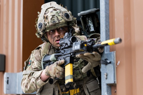 A British soldier takes part in urban combat exercise during a joint military manoeuvre between the French and British army at the Sissonne camp, north of the city of Reims, in northeastern France on  ...