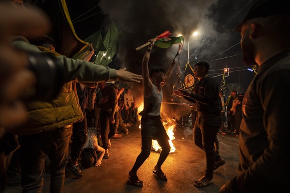 Palestinians celebrate the announcement of a cease-fire after five days of fighting between Israel and the Islamic Jihad militant group in Gaza City, Saturday, May 13, 2023. The two sides agreed to an ...
