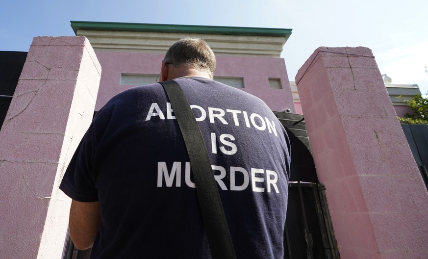 Anti-abortion activist Coleman Boyd reads from the Bible as he seeks to dissuade women from having the medical procedure, while standing outside the Jackson Women&#039;s Health Organization clinic in  ...