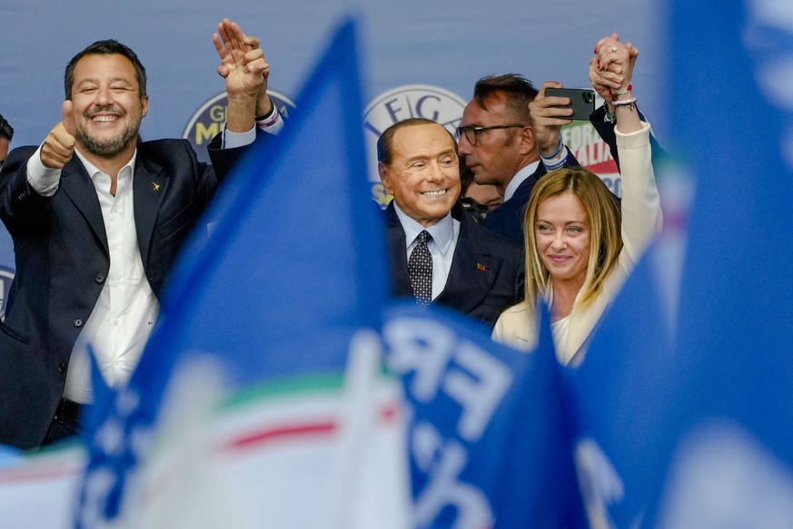 FILE - From left, The League's Matteo Salvini, Forza Italia's Silvio Berlusconi, and Brothers of Italy's Giorgia Meloni attend the final rally of the center-right coalition in central Rome, Thursday,  ...