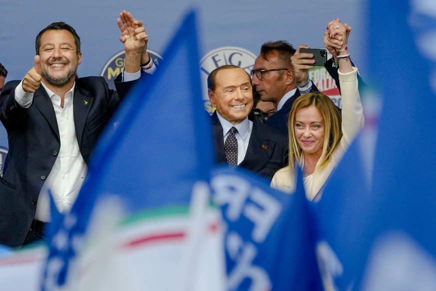 FILE - From left, The League's Matteo Salvini, Forza Italia's Silvio Berlusconi, and Brothers of Italy's Giorgia Meloni attend the final rally of the center-right coalition in central R ...