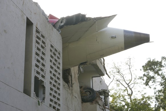 The debris of an airplane sticks out of a building after it crashed in India&#039;s northwestern city of Ahmedabad in Gujarat state, Thursday, June 12, 2025. (AP Photo/Ajit Solanki)
APTOPIX India Plan ...