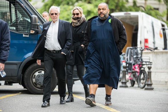 French controversial humorist Dieudonne MBala MBala (right) arrives to the courthouse to testify at the Taric Ramadan trial for a second day of hearing with Geneva&#039;s prosecutor as part of an inve ...