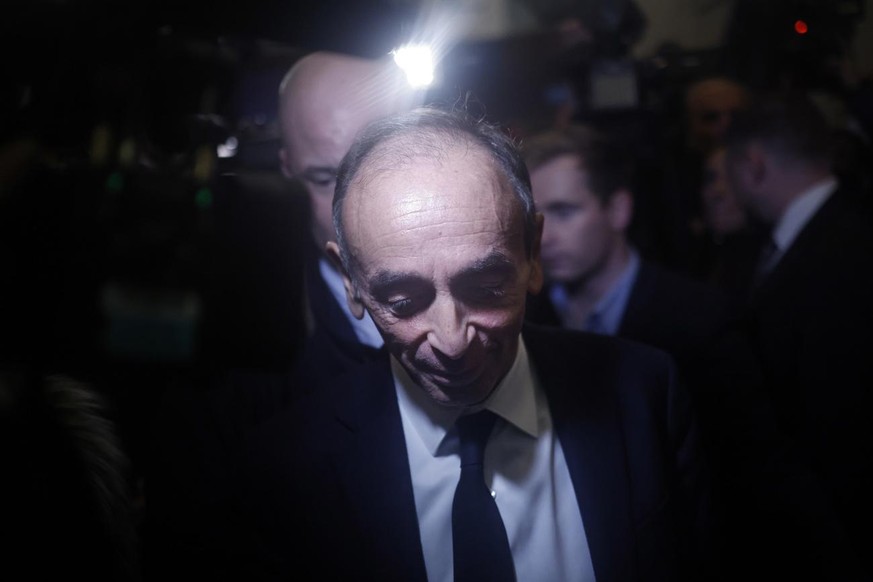 epa09613316 French far-right polemicist and candidate to the 2022 French Presidential elections Eric Zemmour (C) leaves his political campaign headquarters prior to his live interview on French televi ...