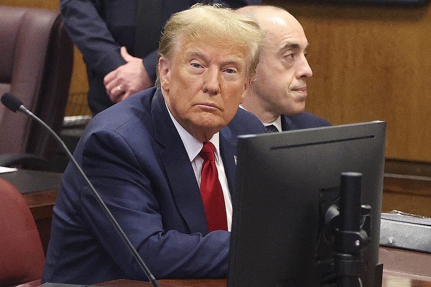 epa11155190 Former U.S. President Donald Trump (L) awaits the start of a hearing at the New York City Criminal Court in New York City, USA, 15 February 2024. Trump is facing 34 felony counts of falsif ...