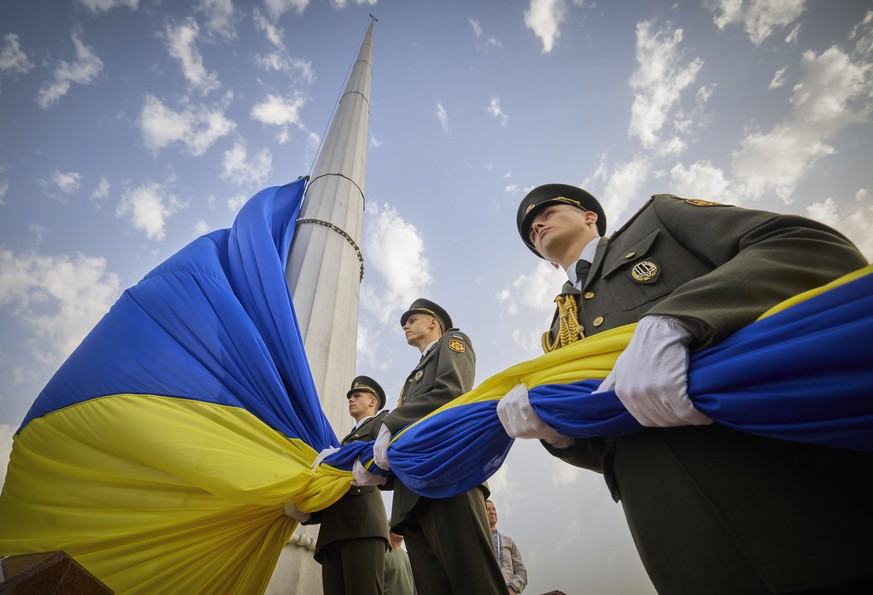 In this photo provided by the Ukrainian Presidential Press Office, honour guard soldiers prepare to rise the Ukrainian national flag during State Flag Day celebrations in Kyiv, Ukraine, Tuesday, Aug.  ...