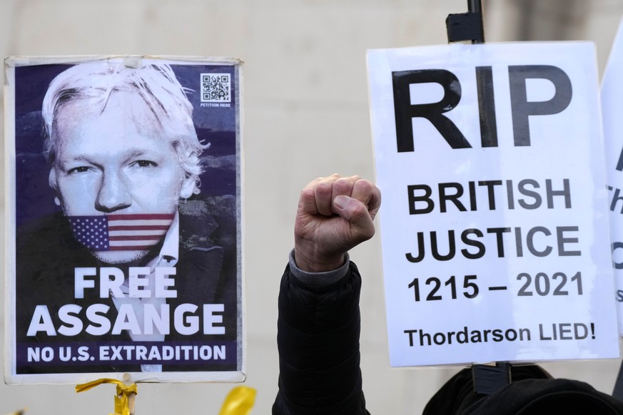 Julian Assange supporters protest in front of the High Court in London, Friday, Dec. 10, 2021. A British appellate court has opened the door for WikiLeaks founder Julian Assange to be extradited to th ...