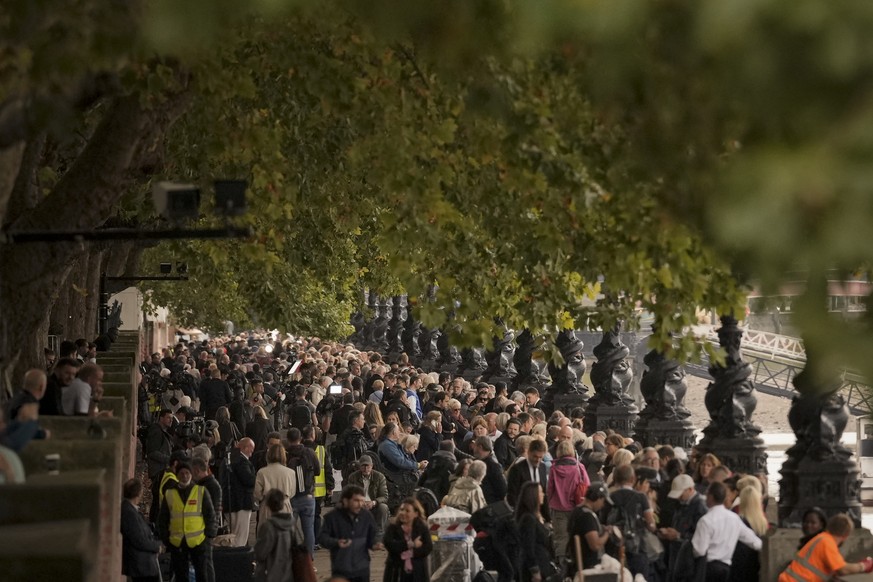 People queue to pay their respects to late Queen Elizabeth II who is lying in state at Westminster Hall in London, Wednesday, Sept. 14, 2022. Queen Elizabeth II, Britain's longest-reigning monarc ...