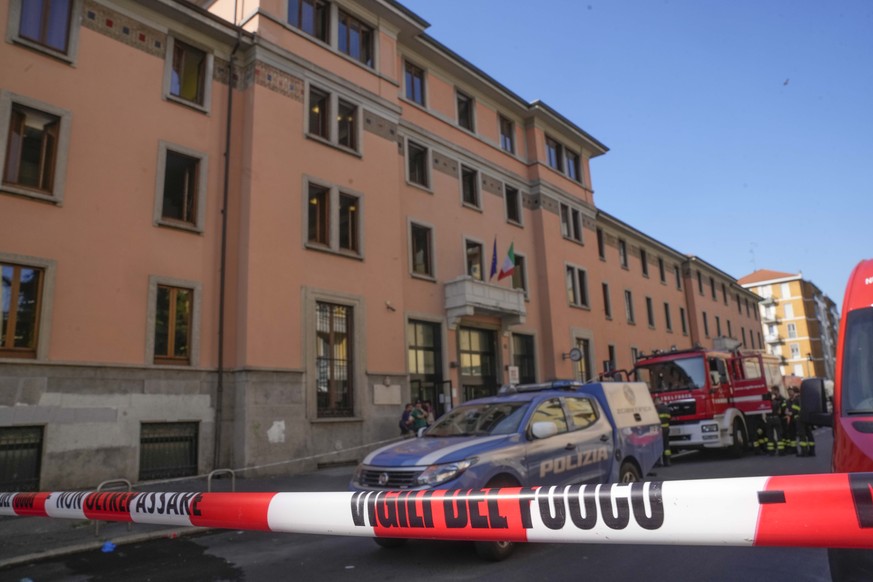 A firefighter truck and a police car are parked outside the &quot;Casa per Coniugi&quot; nursing home where a fire broke out overnight causing the death of six people in Milan, Italy, Friday, July 7,  ...