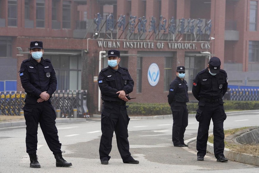 Security personnel gather near the entrance of the Wuhan Institute of Virology during a visit by the World Health Organization team in Wuhan in China&#039;s Hubei province on Wednesday, Feb. 3, 2021.  ...