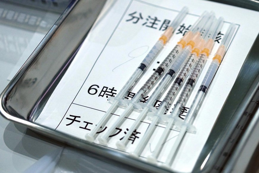 FILE - This July 1, 2021, file photo shows syringes with the Moderna vaccine against COVID-19 disease for Tokyo Metropolitan Government employees at a newly opened vaccination center at the government ...