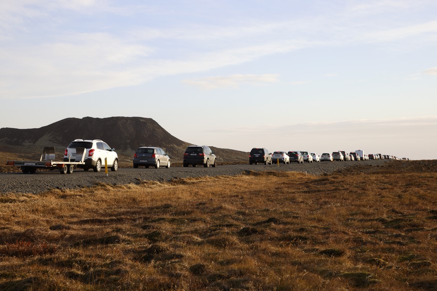 A line of cars queued on a road heading to the town of Grindavik, Iceland Monday Nov. 13, 2023. Residents of Grindavik, a town in southwestern Iceland, have been briefly allowed to return to their hom ...