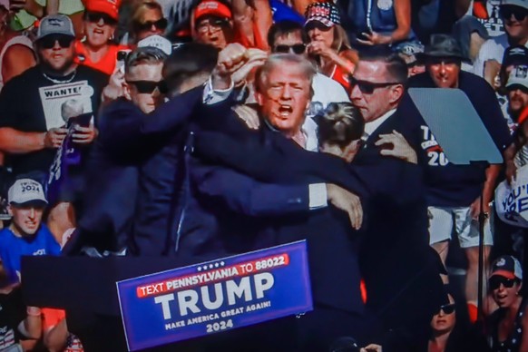 July 14, 2024, Butler, Pennsylvania, United States: In this photo illustration, a screen shows Former US President Donald Trump shot in the ear at a rally he was holding in Butler. Former US President ...