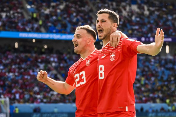 epa10324566 Swiss players Xherdan Shaqiri and Remo Freuler celebrate after their team scored the opening goal during the FIFA World Cup 2022 group G soccer match between Switzerland and Cameroon at Al ...