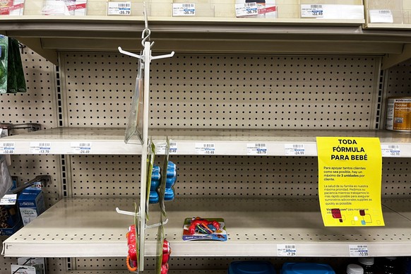 epa09959386 A sign stuck on an empty shelve reads in Spanish &#039;All baby formula, to support as many customers as possible, there is a maximum of three units per customer.&#039; at a CVS pharmacy i ...