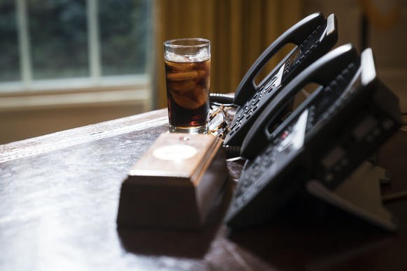 WASHINGTON, DC - FEBRUARY 14: A glass of iced soda is seen on the Resolute Desk as President Donald Trump speaks during a meeting about the opportunity zones provided by tax reform in the Oval Office  ...