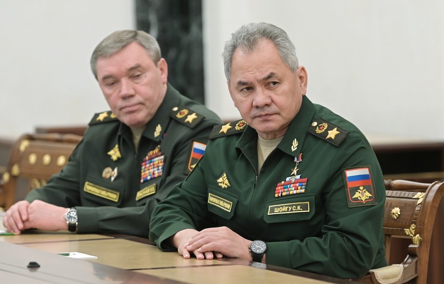 Russian Defense Minister Sergei Shoigu, right, and Head of the General Staff of the Armed Forces of Russia and First Deputy Defense Minister Valery Gerasimov listen to Russian President Vladimir Putin ...