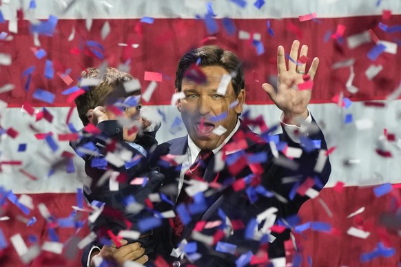 Incumbent Florida Republican Gov. Ron DeSantis holds his son Mason as he celebrates winning reelection, at an election night party in Tampa, Fla, Tuesday, Nov. 8, 2022. (AP Photo/Rebecca Blackwell)