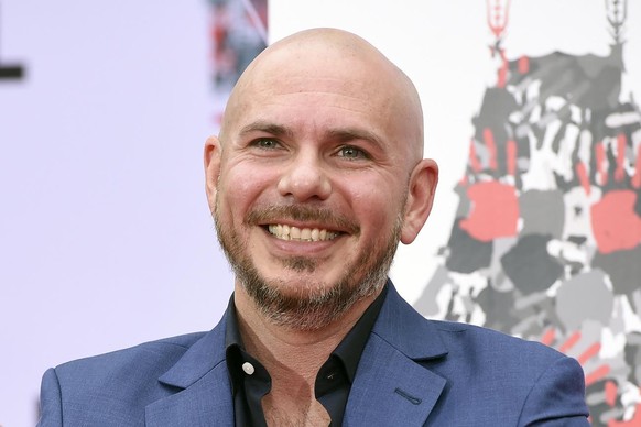 FILE - Pitbull smiles during a hand and footprint ceremony at the TCL Chinese Theatre in Los Angeles, in this Friday, Dec. 14, 2018, file photo. NASCAR is being heavily promoted by a broadcast partner ...