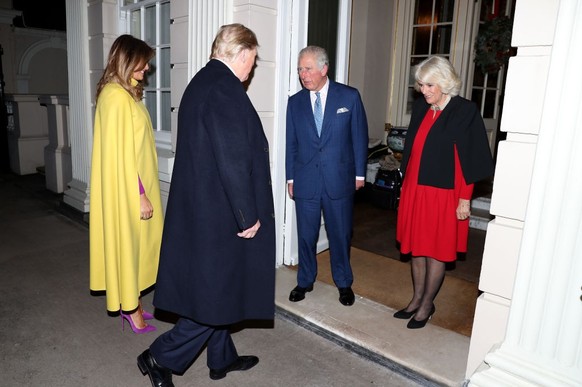 LONDON, ENGLAND - DECEMBER 03: First lady Melania Trump and US President Donald Trump are greeted by Prince Charles, Prince of Wales and Camilla, Duchess of Cornwall as they attend Tea at Clarence Hou ...