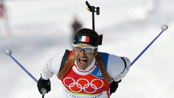 French biathlete Vincent Defrasne celebrates while crossing the finish line to win the gold medal in the men&#039;s 12.5km pursuit race at the Olympic biathlon track in San Sicario, Italy, Saturday 18 ...