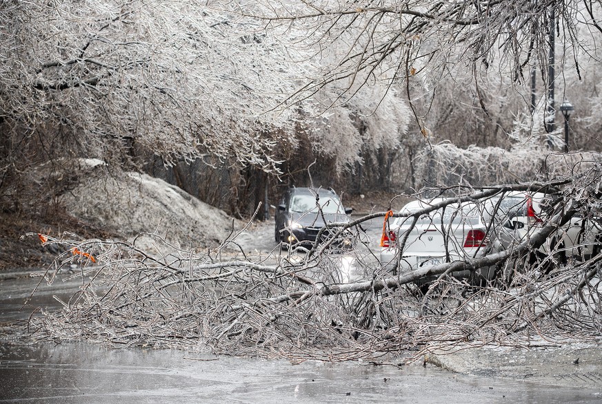 Fallen tree branches block a street following an accumulation of ice rain in Montreal, Wednesday, April 5, 2023. (Graham Hughes/The Canadian Press via AP)