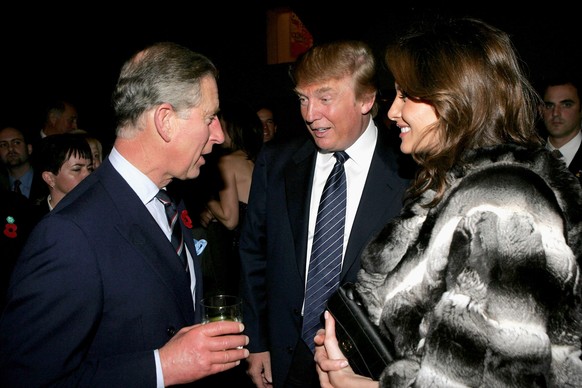 NEW YORK - NOVEMBER 01: Prince Charles (L) chats with businessman Donald Trump and his wife, Melania Trump, during the Museum of Modern Art (MOMA) reception on the first day of the royal eight-day vis ...
