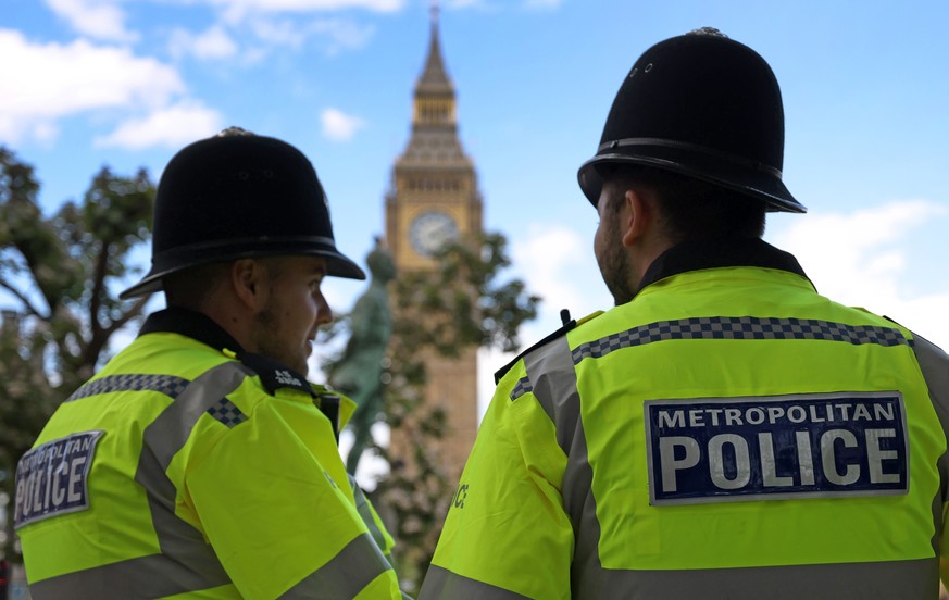 epa10727717 Policemen stand guard outside parliament in London, Britain, 05 July 2023. The Met Police have announced they are to reopen investigations into potential Covid breaches during a Tory party ...