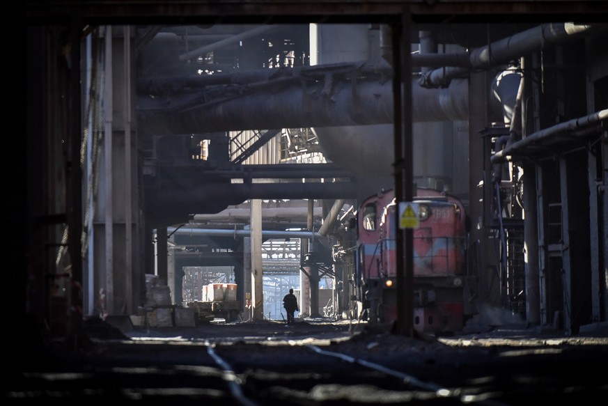 epa10485339 A worker walks the premises of a blast furnace shop at the Zaporizhstal steel plant in Zaporizhia, southeastern Ukraine, 20 February 2023 (issued 23 February 2023), amid Russia's inva ...