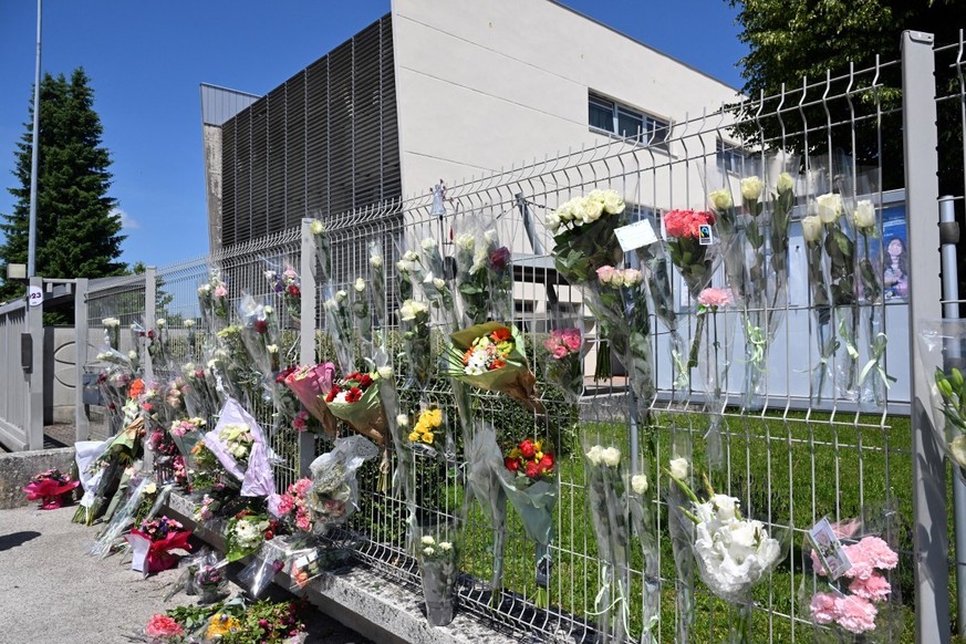 This photograph shows flowers on the fence of Francoise Dolto middle school in Nogent on June 11, 2025, a day after a secondary school pupil was arrested after killing a 31-year-old school assistant w ...