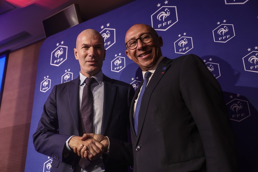 epa13136888 President of the French Soccer Federation Philippe Diallo (R) shakes hands with the new head coach of the French men's national soccer team Zinedine Zidane (L) at the french soccer fe ...