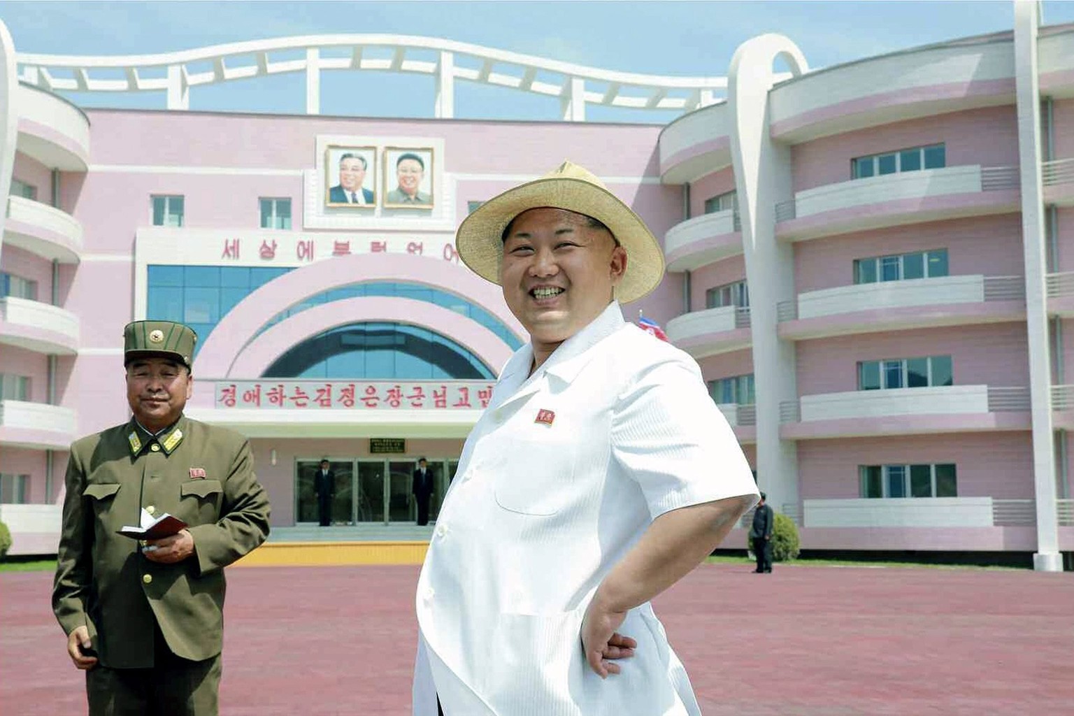 epa04779499 A picture released by the Rodong Sinmun, the newspaper of the North Korea ruling Workers Party, on 02 June 2015 shows North Korean leader Kim Jong-un (C) visiting a newly constructed nurse ...